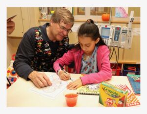 Foundation President Carl Nelson draws with a patient at Montefiore.